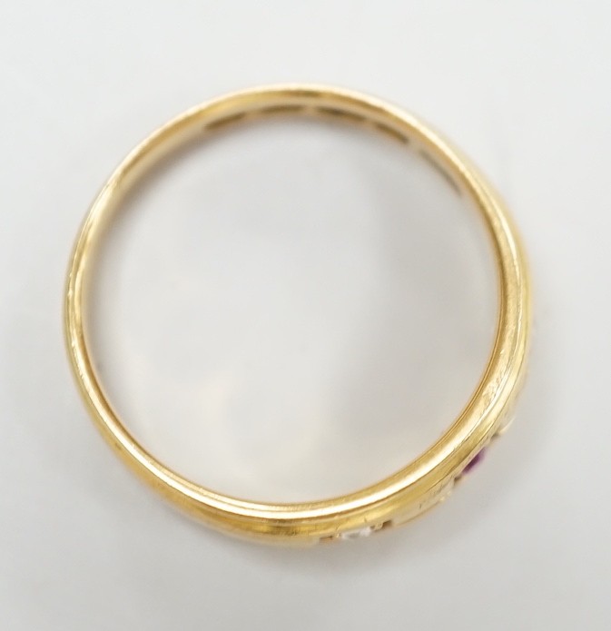 A late Victorian 18ct gold, ruby and diamond set three stone ring, size K/L, gross weight 4 grams.